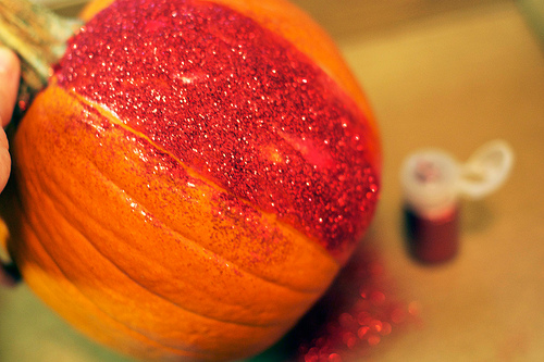 adding glitter -rainbow glitter pumpkin